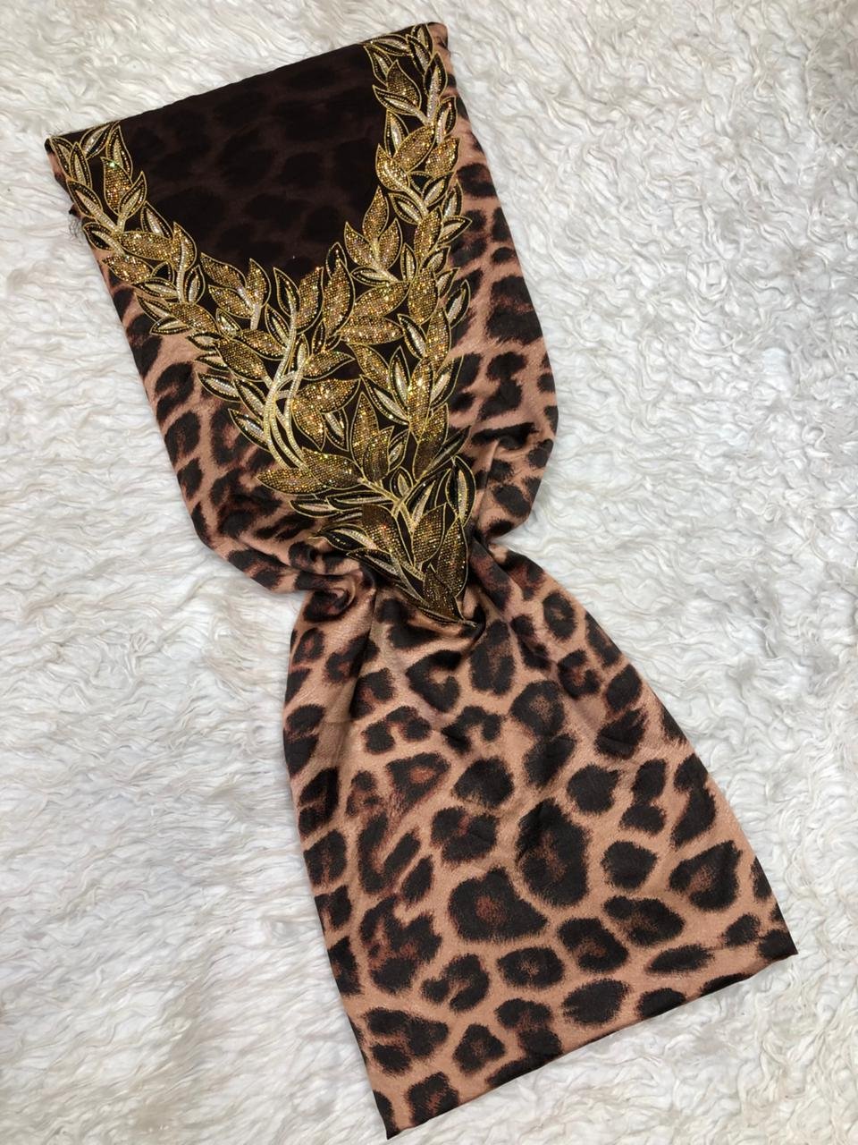 embroidered beige fabric – leaf vine design with golden accents Beige fabric with intricate gold leaf embroidery and vine patterns for fashion or home décor